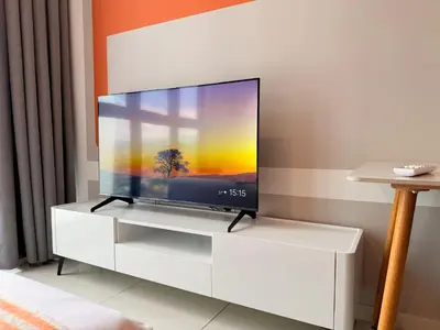 a flat screen tv sitting on a white entertainment center at MH Rest House at Majestic Residence in Kuala Lumpur