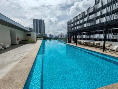 a large swimming pool on the side of a building at Vivo Soho - 2 Bedrooms, Mid Valley, Bangsar South, Campus Rangers in Kuala Lumpur
