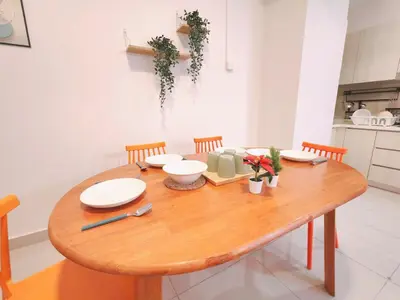 a wooden table with plates and utensils on it in a kitchen at Vivo Soho - 2 Bedrooms, Mid Valley, Bangsar South, Campus Rangers in Kuala Lumpur