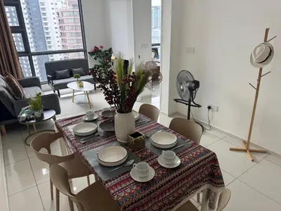 a dining room table with chairs and a vase of flowers at Robertson S15 KLCC Alor Street Bukit Bintang 5Pax in Kuala Lumpur