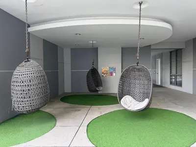 a room with three hanging chairs and green carpet at Robertson S15 KLCC Alor Street Bukit Bintang 5Pax in Kuala Lumpur