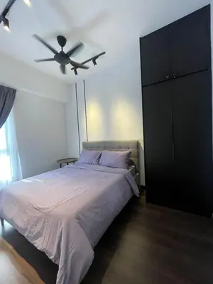 a bedroom with a bed and a ceiling fan at KL Nice Condo in Kuala Lumpur