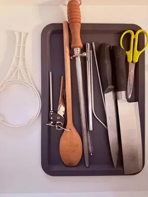 a tray filled with various kitchen utensils on a counter at EST Establishment Bangsar in Kuala Lumpur