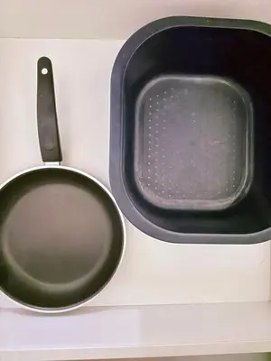 a close up of a black bowl and a microwave at EST Establishment Bangsar in Kuala Lumpur