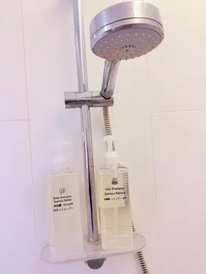 a light with two bottles on a shelf in a bathroom at EST Establishment Bangsar in Kuala Lumpur