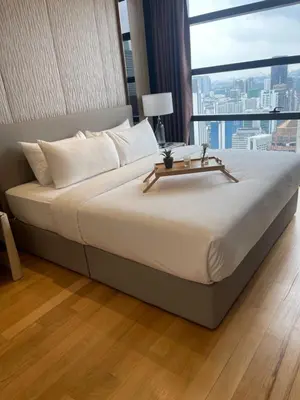 a large bed in a room with a large window at Majestic Residence Klcc by Apple in Kuala Lumpur