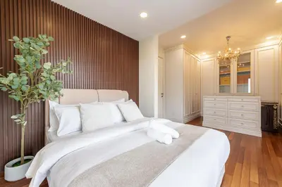 a bedroom with a large white bed with white pillows at The Noble Bungalow, 18pax 5R4B near Datuk Keramat, KL Pavilion in Kuala Lumpur