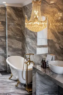 a bathroom with a tub and a chandelier at The Noble Bungalow, 18pax 5R4B near Datuk Keramat, KL Pavilion in Kuala Lumpur