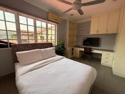 a bedroom with a bed and a desk with a television at Grand Luxe Bangalow 8BR, Ampang Utama Park, LRT in Ampang