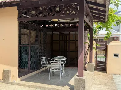 a patio with a table and chairs under awning at Grand Luxe Bangalow 8BR, Ampang Utama Park, LRT in Ampang