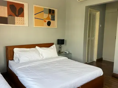 a bedroom with a large bed with white sheets at Grand Luxe Bangalow 8BR, Ampang Utama Park, LRT in Ampang