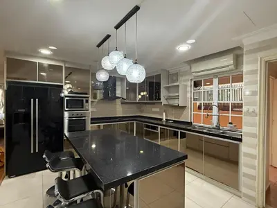 a large kitchen with a black counter and appliances at Grand Luxe Bangalow 8BR, Ampang Utama Park, LRT in Ampang