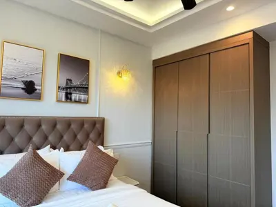 a bedroom with a bed and a large wooden cabinet at Bukit Bintang Agile 400m to TRX DualKey 2-7pax in Kuala Lumpur