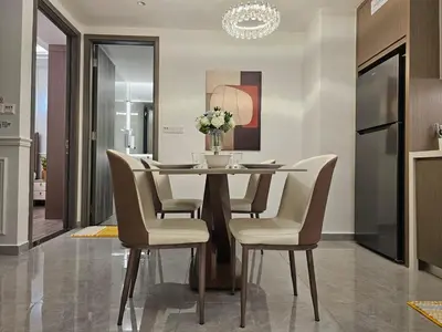 a dining room table with chairs and a vase of flowers at Bukit Bintang Agile 400m to TRX DualKey 2-7pax in Kuala Lumpur