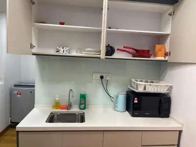 a kitchen with a sink and a microwave at INFINITUM Stay at klcc in Kuala Lumpur