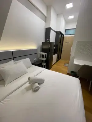 a bedroom with a white bed with a towel on it at INFINITUM Stay at klcc in Kuala Lumpur