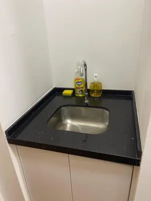 a kitchen sink with a black counter top at INFINITUM Stay at klcc in Kuala Lumpur