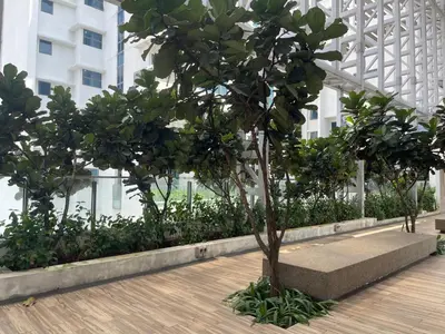 a tree in the middle of a building at INFINITUM Stay at klcc in Kuala Lumpur