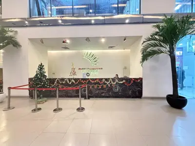 a lobby with a christmas tree in the center at CozyNest KLCC at Mercu Summer Suites in Kuala Lumpur