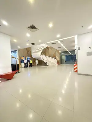 an empty lobby with a staircase in a building at CozyNest KLCC at Mercu Summer Suites in Kuala Lumpur