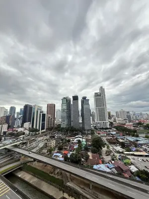 a city skyline with tall buildings and a highway at CozyNest KLCC at Mercu Summer Suites in Kuala Lumpur
