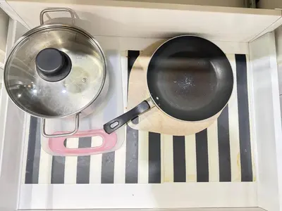 a frying pan and a pan in a stove at CozyNest KLCC at Mercu Summer Suites in Kuala Lumpur