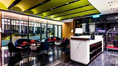 a lobby with chairs and tables in a building at Imperial Residence KLCC - MJ Home in Kuala Lumpur
