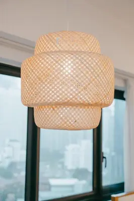 a brown and white lamp shade in front of a window at Cozy Minimalist Studio KL, Agile Residence Bukit Bintang in Kuala Lumpur