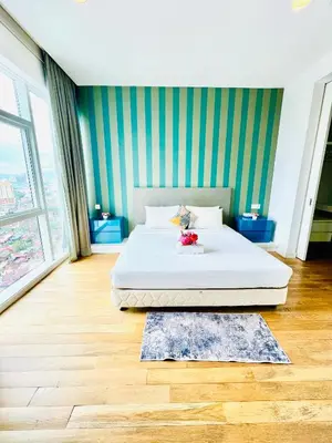 a bedroom with a white bed and a green wall at Peace Pavilion At Platinum in Kuala Lumpur
