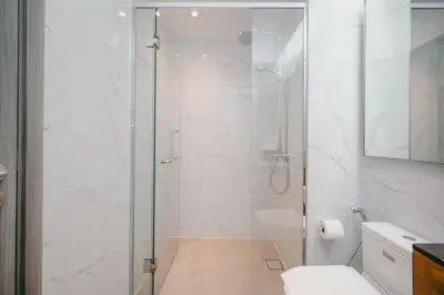 a shower with a glass door in a bathroom at Modern Cozy Home Kuala Lumpur, Agile Residence Bukit Bintang in Kuala Lumpur