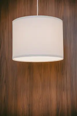 a white light fixture hanging from a wooden wall at Modern Cozy Home Kuala Lumpur, Agile Residence Bukit Bintang in Kuala Lumpur