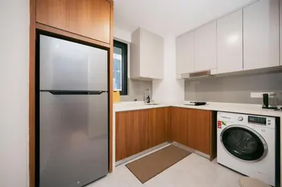 a kitchen with a refrigerator and a washing machine at Modern Cozy Home Kuala Lumpur, Agile Residence Bukit Bintang in Kuala Lumpur