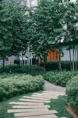 a walkway in a park with trees and a building at Modern Cozy Home Kuala Lumpur, Agile Residence Bukit Bintang in Kuala Lumpur