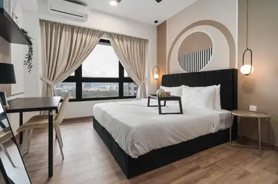 a bedroom with a bed and a table and a desk at Grand 2BR Agile Bukit Bintang BY RumaBnB in Kuala Lumpur