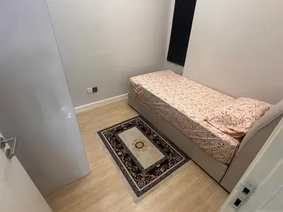 a small bedroom with a bed and a rug at Desa green apartment in Kuala Lumpur