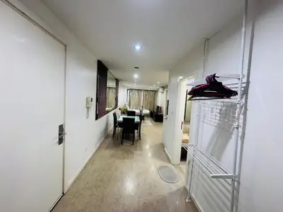 a hallway with a room with a table and shoes on a shelf at Fairlane Bukit Bintang by Lily in Kuala Lumpur