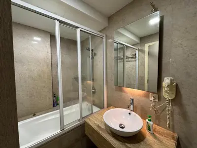 a bathroom with a sink and a shower and a tub at Fairlane Bukit Bintang by Lily in Kuala Lumpur