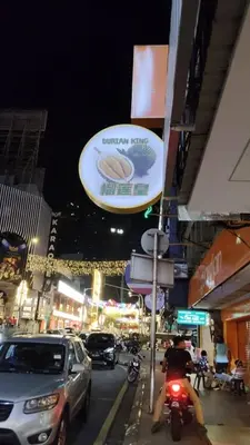 a city street at night with cars and a sign at SHAMA HoTEL in Kuala Lumpur