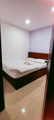a bed in a room with a door open at SHAMA HoTEL in Kuala Lumpur