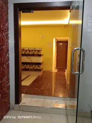 a reflection of a room in a glass door at SHAMA HoTEL in Kuala Lumpur