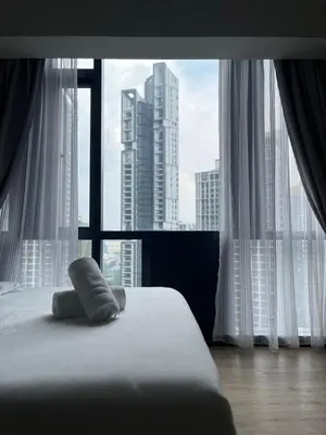 a bed in a room with a large window at KL Star Residance in Kuala Lumpur