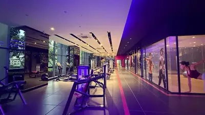 a shopping mall with a woman in a store at KL Star Residance in Kuala Lumpur