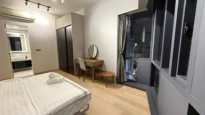 a bedroom with a bed and a desk with a mirror at KL Star Residence KLCC in Kuala Lumpur