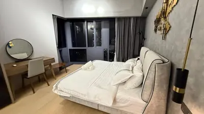 a bedroom with a bed and a desk and a mirror at KL Star Residence KLCC in Kuala Lumpur
