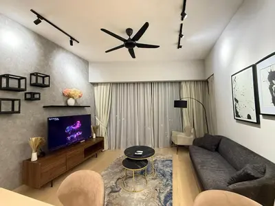 a living room with a couch and a ceiling fan at KL Star Residence KLCC in Kuala Lumpur