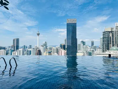 a infinity pool with a view of a city at Supper Suite By Axon Residence in Kuala Lumpur
