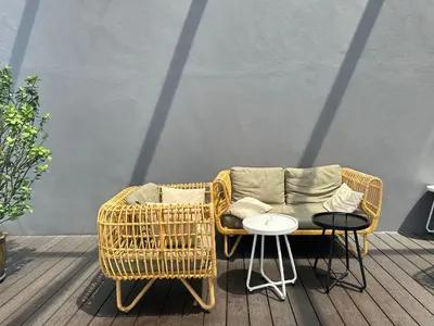 a wicker chair and table next to a wicker couch at Supper Suite By Axon Residence in Kuala Lumpur
