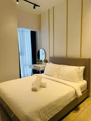 a bedroom with a large white bed with a window at Supper Suite By Axon Residence in Kuala Lumpur