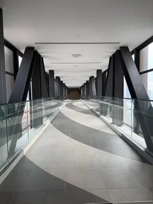 an empty hallway in a building with glass walls at Astra At Axon Bukit Bintang KL in Kuala Lumpur