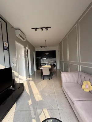 a living room with a couch and a table at Astra At Axon Bukit Bintang KL in Kuala Lumpur